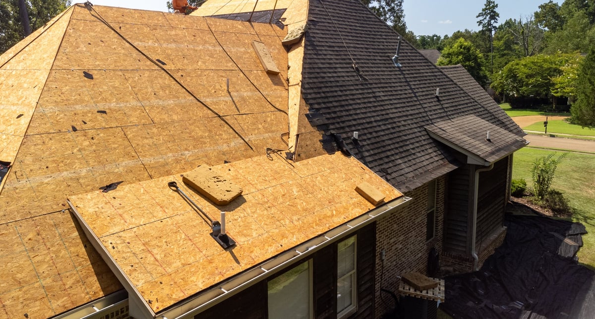 House with a new roof being installed after hail damage
